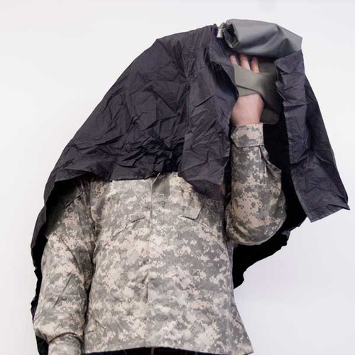 Removable viewing hood conceals screen light; can also be used in bright light to eliminate screen glare.  Shown being used by someone in military uniform.