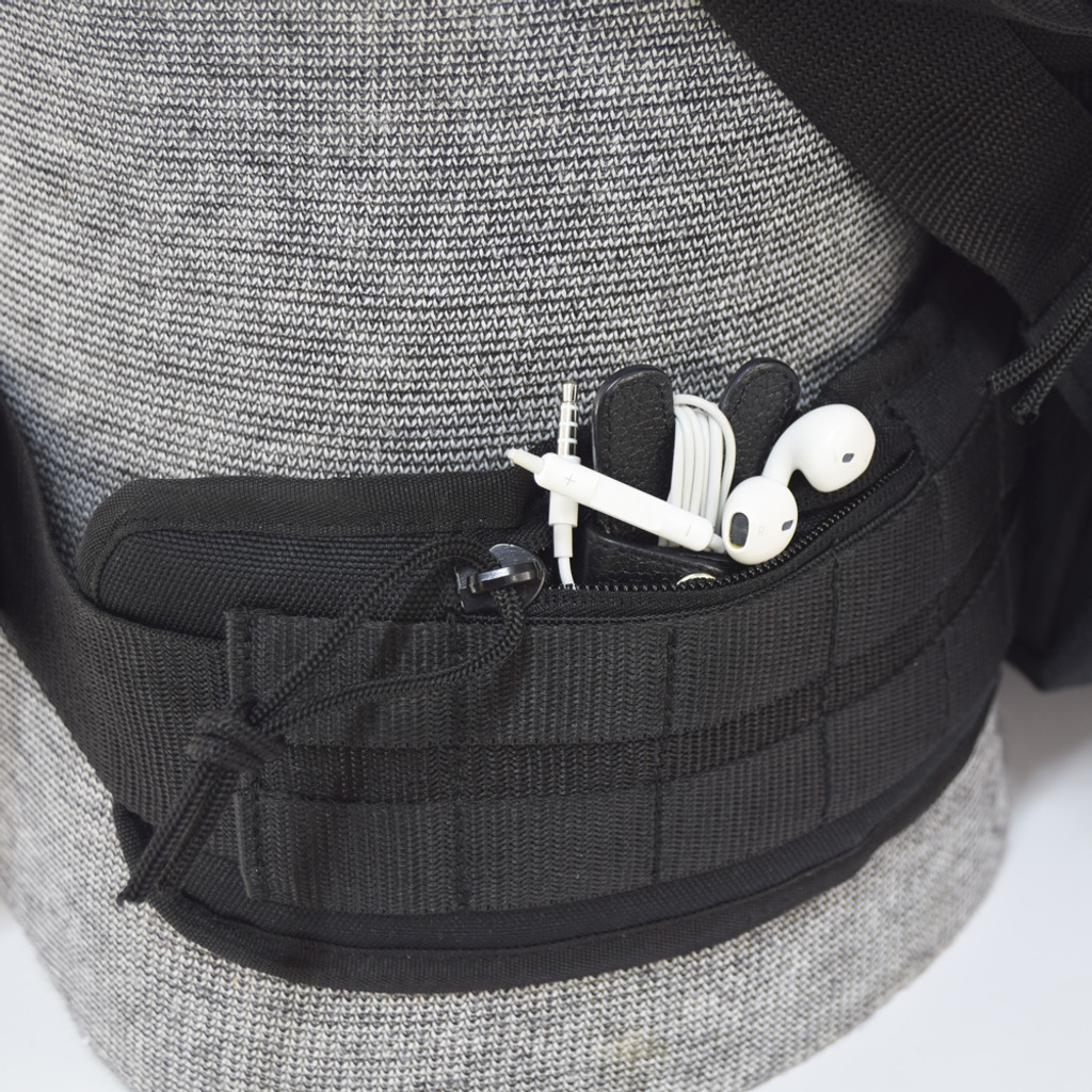 Padded, heavy duty, removable waist strap with two small zipper pockets for keys, wallet, and mobile phone, etc.  Shown with ear buds inside on Brazos Concealed Carry Backpack in black.
