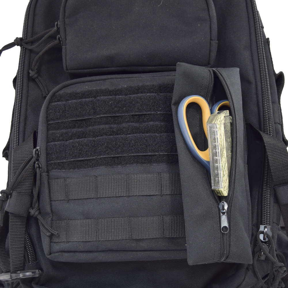 MOLLE on front for clip on items and pouches, shown with scissors inside attached pouch on Brazos Concealed Carry Backpack in black.