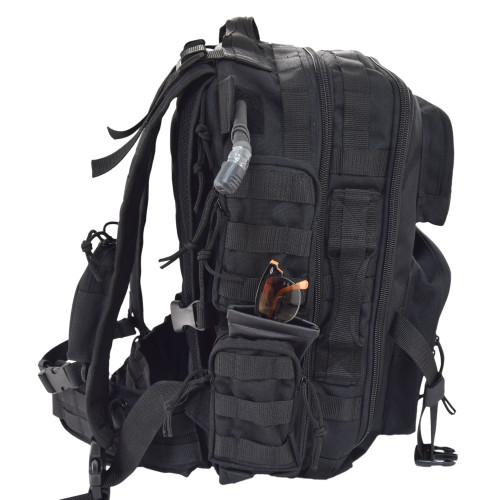 Brazos Concealed Carry Backpack in black with side pockets, MOLLE webbing and compression straps on side, shown with glasses in side pocket and hydration reservoir tubing.