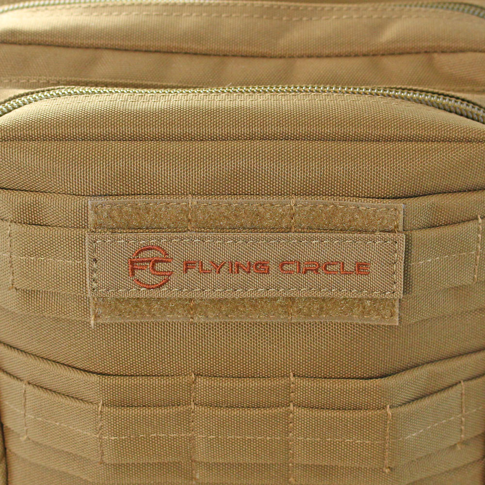 Removable Flying Circle patch on top front pocket of coyote brown Midland Backpack.