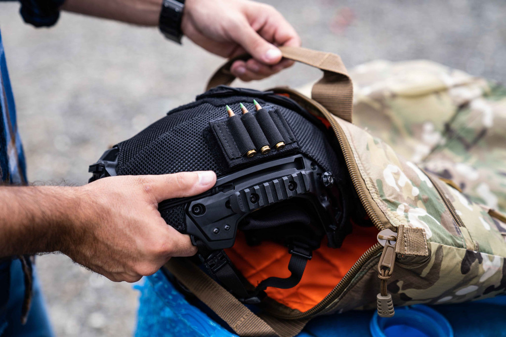 Helmet being placed inside Deluxe Helmet Bag, perfect for carrying and protecting aviation, motorcycle, and other helmets. 