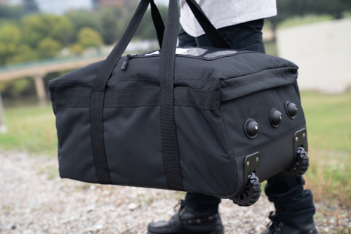Mini Buffalo Rolling Duffel in Black carried as duffel.