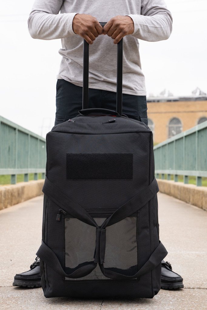 Mini Buffalo Rolling Duffel in Black upright on wheels.