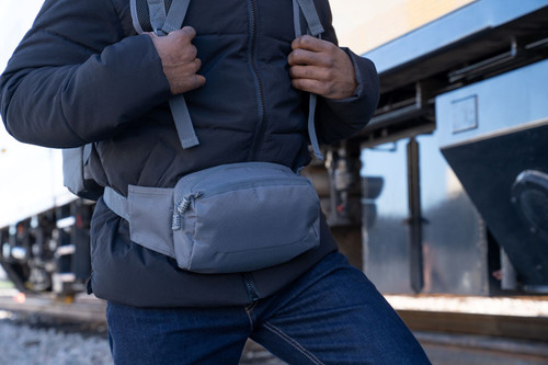 EDC Sling Bag & Waist Pack  in Gun Metal worn around waist with backpack.