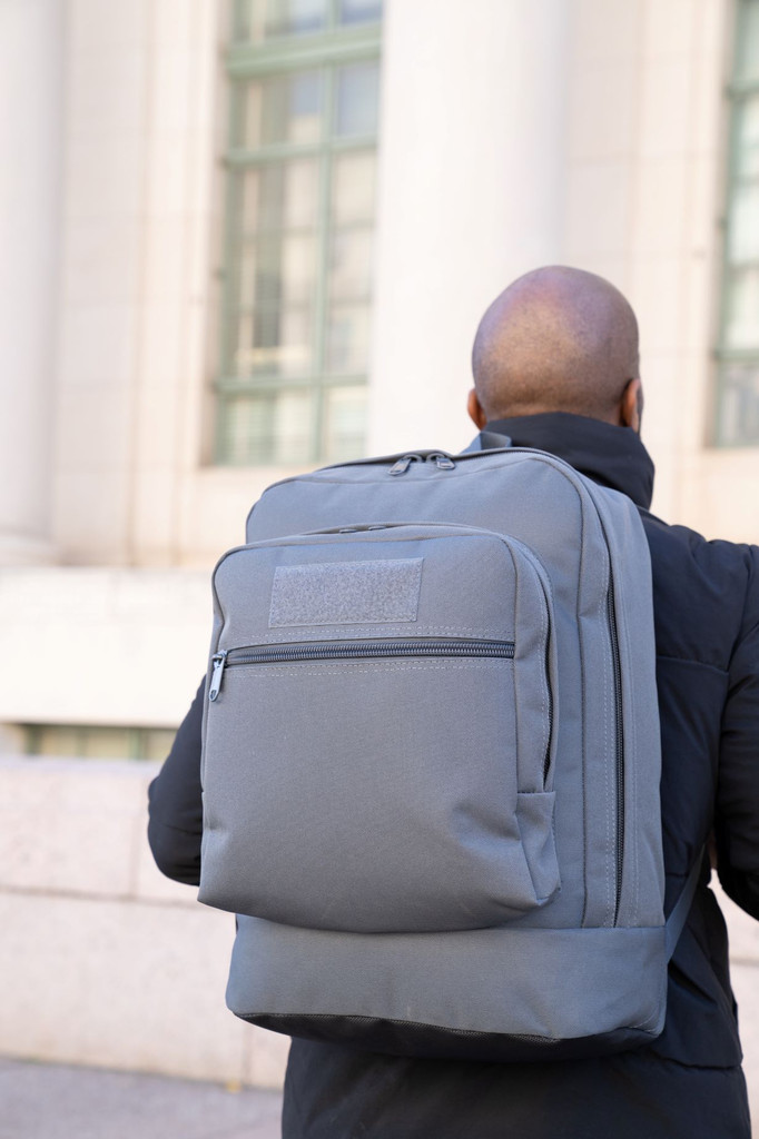 Utility Backpack in gun metal gray worn on back.