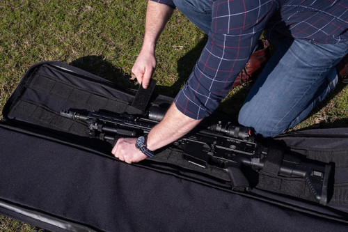 Securing firearm inside the black Single Rifle Case.