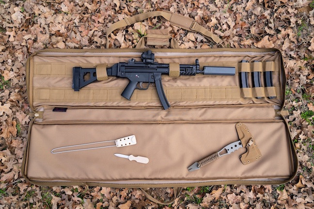 Coyote brown Single Rifle Case shown outdoors opened with firearm secured inside.