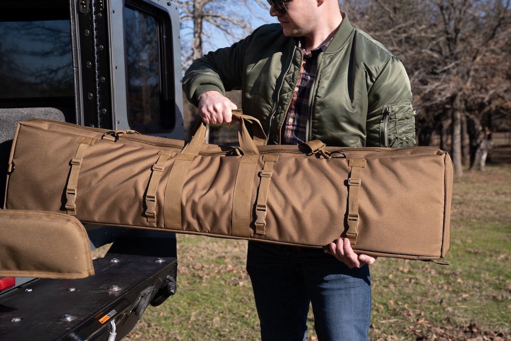 Coyote brown Single Rifle Case being loaded into vehicle.