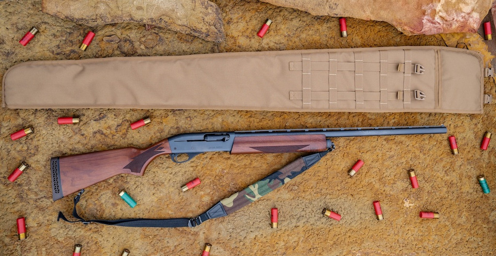 A coyote brown Shotgun Scabbard on a brown rock surface laying above a brown and black rifle with a camo strap attached to it and red and green shotgun shells scattered around it.