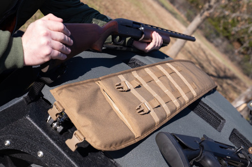 Shotgun held next to coyote brown Shotgun Scabbard.