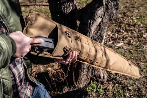 Shotgun being removed from coyote brown Shotgun Scabbard.