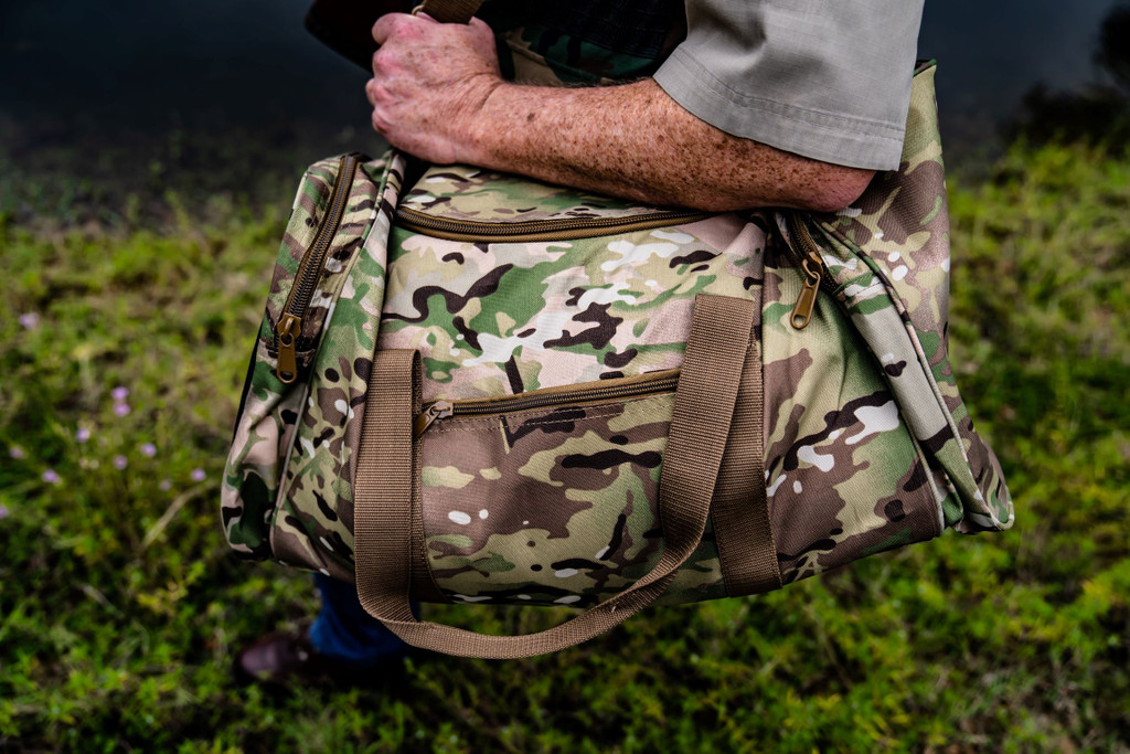 MultiCam® Large Square Duffel carried on shoulder.
