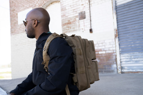 Side view of coyote brown Midland Backpack worn on back.