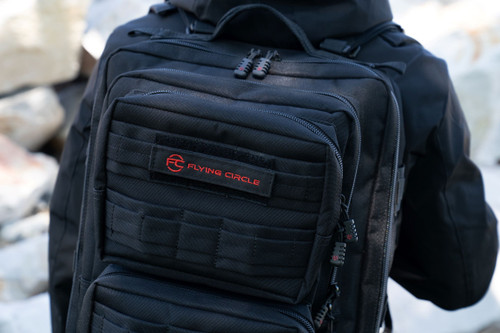 Close up of Flying Circle patch in red letters on black Midland Backpack.